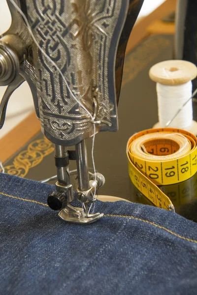 Sewing machine and item of clothing material — Stock Photo, Image