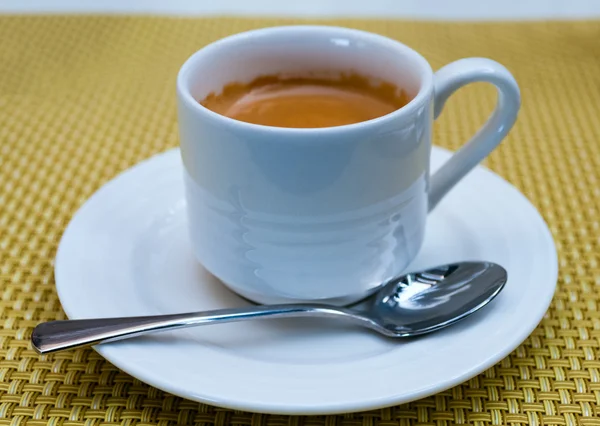 Cup of tea on saucer with a spoon — Stock Photo, Image