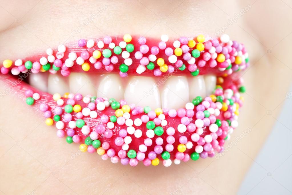 Womans lips with colored candy — Stock Photo © AnmFoto 12847851