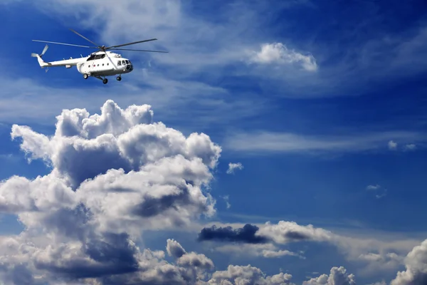 Helicopter in blue sky with clouds — Stock Photo, Image