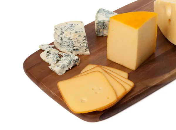 Different types of cheese on wooden kitchen board — Stock Photo, Image