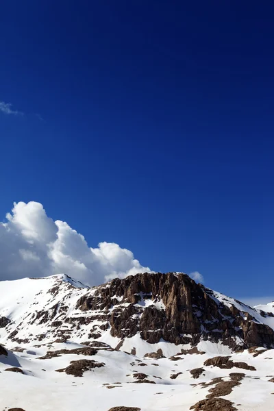 Rocks in snow and blue sky Stock Image