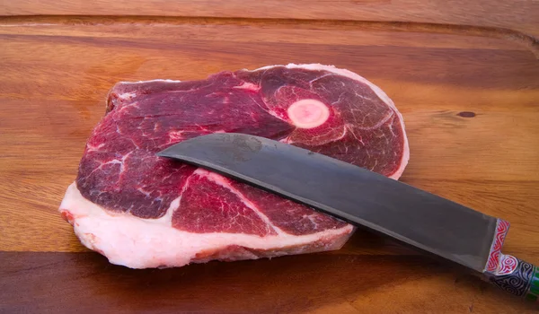 Raw meat with national uzbek knife — Stock Photo, Image