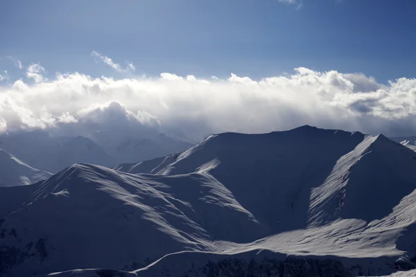 Winter mountains in evening and paragliders — Stock Photo, Image