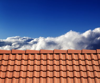 Roof tiles and sunny sky with clouds clipart