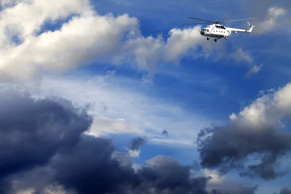 Helicopter in blue sky with clouds — Fotografia de Stock