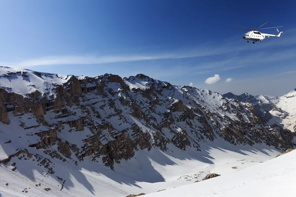 Helicopter in snowy sunny mountains — Stock Photo, Image