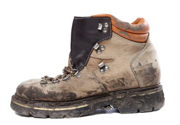 Old trekking boot in mud. Side view. — Stock Photo, Image