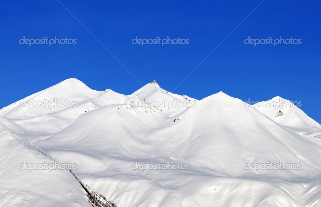 Snowy mountains and blue sky at nice day