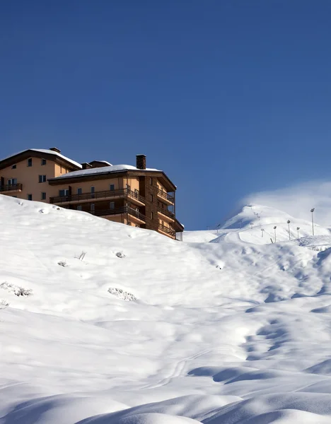 Off-piste slope and hotel at sun day Stock Photo