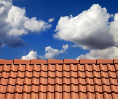 Roof tiles and cloudy sky clipart