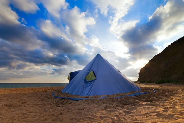 Conical tent on summer beach and blue sky with clouds — Stock Photo, Image