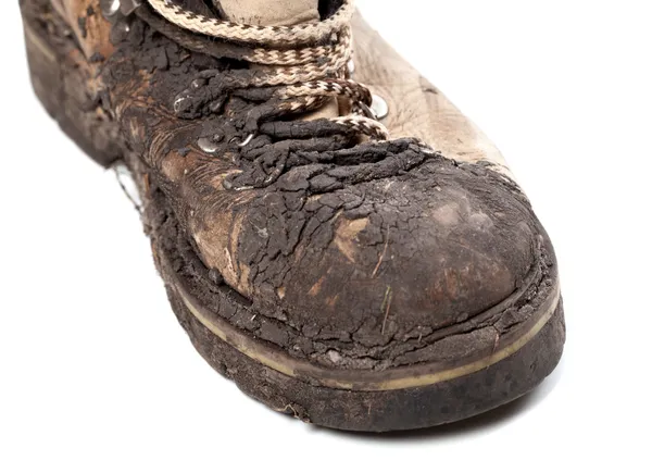 Part of old dirty hiking boot on white background — Stock Photo, Image