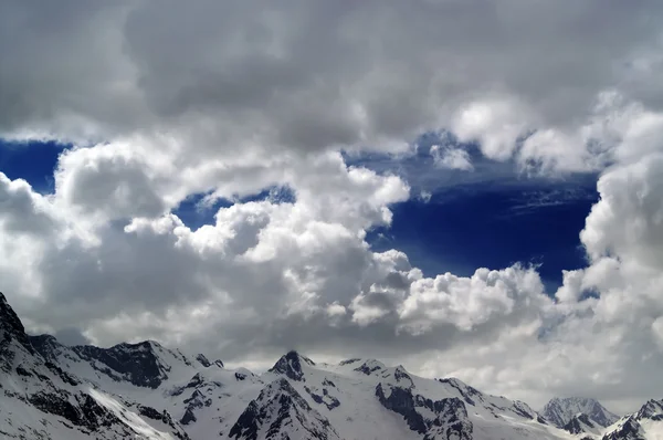 Besneeuwde bergen in mooie wolken — Stockfoto