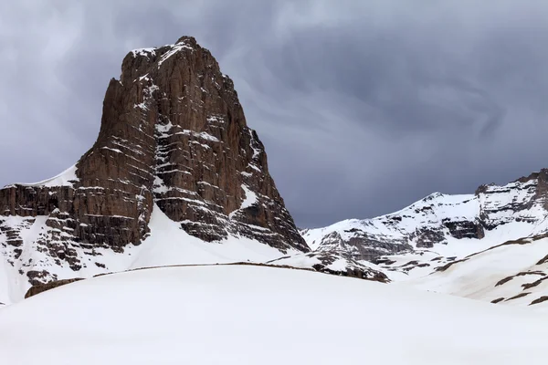 Снежные скалы и серое небо — стоковое фото
