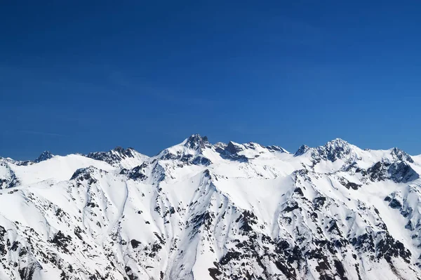 雪に覆われた山と太陽の寒い日に青空 冬のコーカサス山脈ドムベイ地方からの眺め — ストック写真