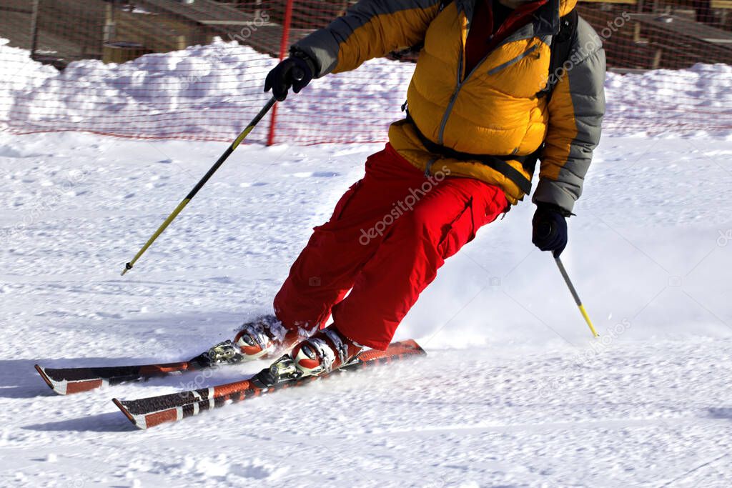 Ski finish in downhill at sun winter day