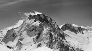 Black and white panorama of winter snowy mountain. Caucasus Mountains. Region Dombay, mount Dombay-Ulgen.