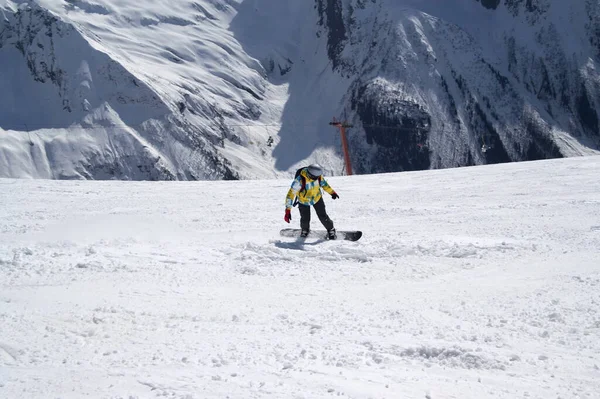 Słoneczny Zimowy Dzień Snowboardzista Zjeżdża Stok Narciarski Wysokich Śnieżnych Górach — Zdjęcie stockowe