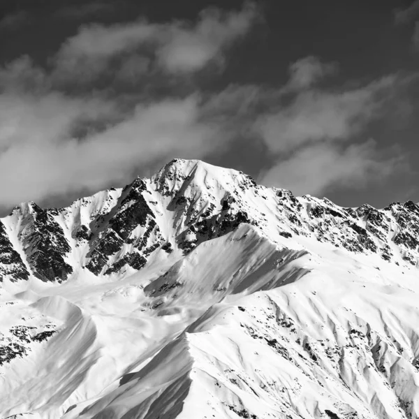 Black and white snow mountain peak at sunny day. View from chair lift on Hatsvali, Svaneti region of Georgia. Caucasus Mountains in winter. Square image.