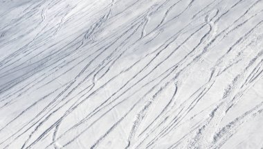 Buz gibi kış gününde kayak ve snowboard izleri ile serbest dolaşmak için karlı bir kayak yamacı.