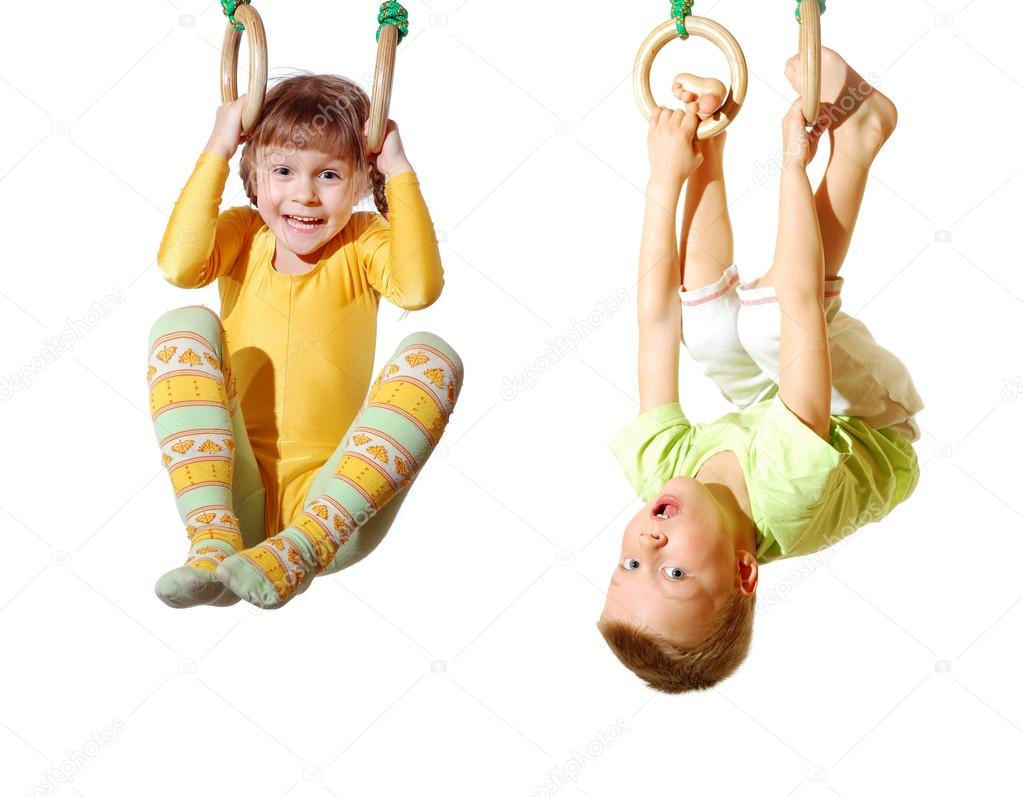 children playing and exercising on gymnastic rings