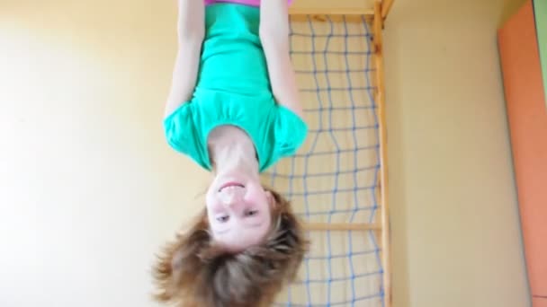 Child playing and exercising on gymnastic rings — Stock Footage Child playing and exercising on gymnastic rings Royalty Free Stock Footage