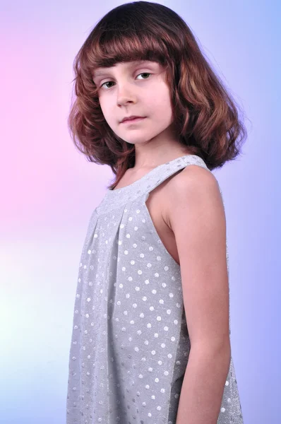 Pretty 8 year old girl in silver dress — Stock Photo, Image