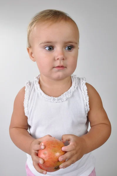 Toddler with an apple — Stock Photo, Image