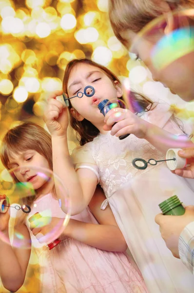 Holiday portrait of happy children against bright background — Stock Photo, Image