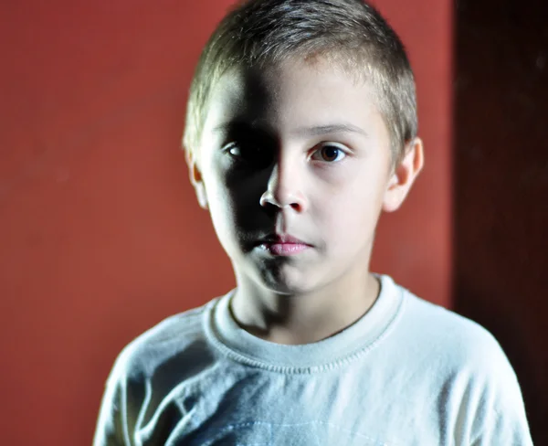 Serious face of a small boy — Stock Photo, Image