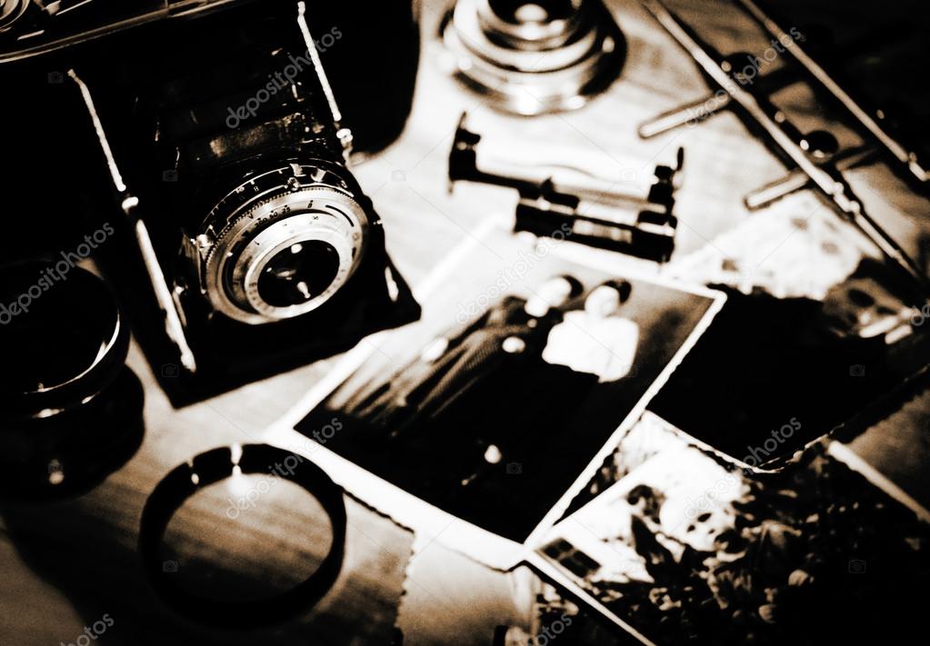 Vintage still life with retro photo camera and old photos