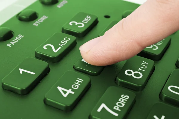 Büro grünes Telefon mit Finger — Stockfoto