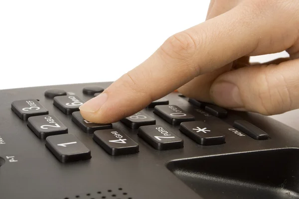 Büro schwarzes Telefon mit isolierter Hand auf weißer — Stockfoto