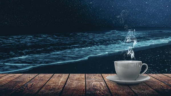 hot coffee on the table against the background of the sea dawn