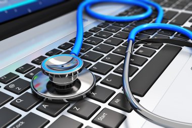 Stethoscope on laptop keyboard clipart