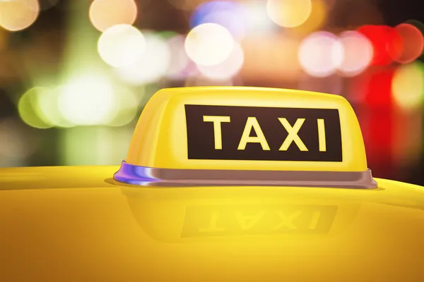 Yellow taxi sign on car — Stock Photo, Image