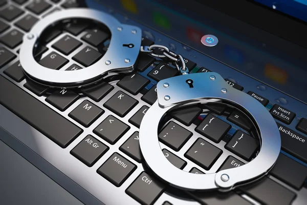 Handcuffs on laptop keyboard — Stock Photo, Image