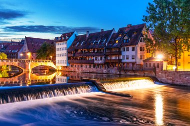 Scenic summer night view of the bridge over Pegnitz River in the Old Town of Nurnberg, Bavaria, Germany clipart