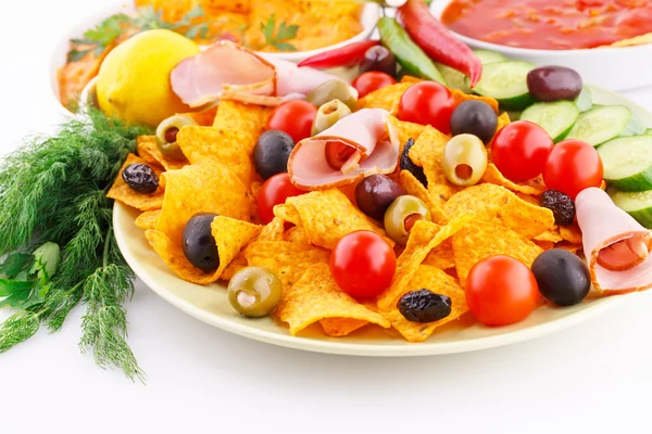 Nachos, olives, pork loin and vegetables — Stock Photo, Image