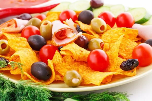 Nachos, olives, pork loin and vegetables — Stock Photo, Image