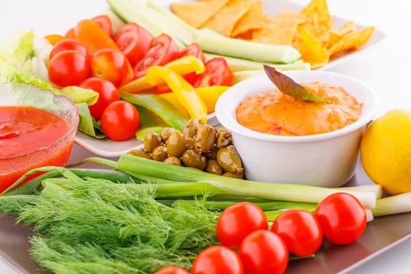 Vegetables, olives, nachos, red and cheese sause — Stock Photo, Image