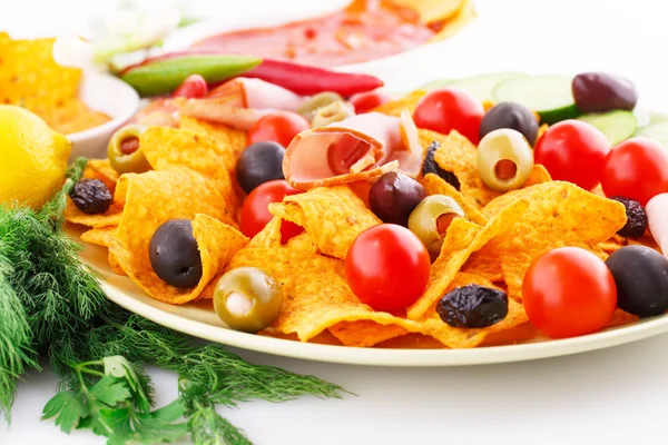 Nachos, olives, pork loin and vegetables — Stock Photo, Image