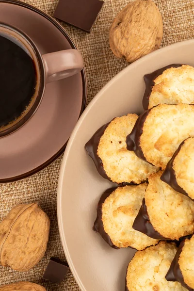 Coconut Cookies Beige Plate Cup Coffee Walnuts Chocolate Burlap Background — Stockfoto