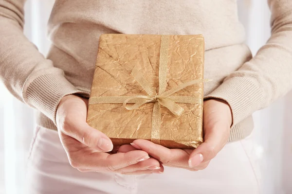 Christmas present in golden wrap — Stock Photo, Image