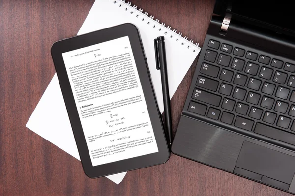 Laptop and digital tablet with mathematical article — Stock Photo, Image