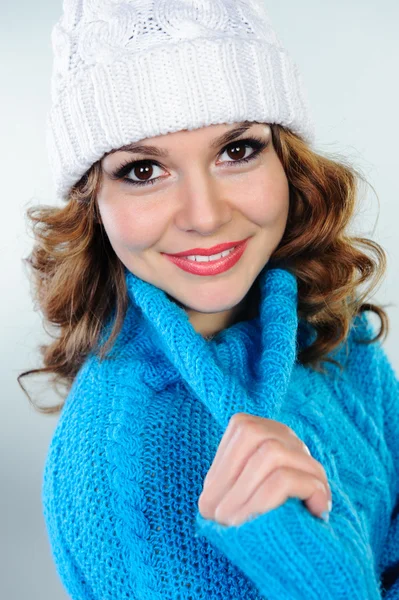 Portrait of beautiful young woman in blue knitted sweater — Stock Photo, Image