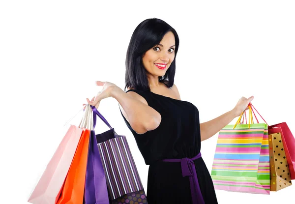 Jovem morena com sacos de compras isolados em branco — Fotografia de Stock