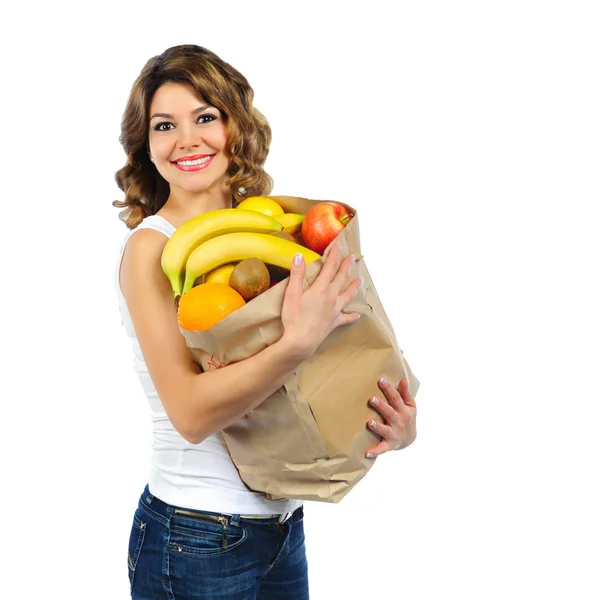 Young girl with fruits in paper bag isolated on white — Stock Photo, Image