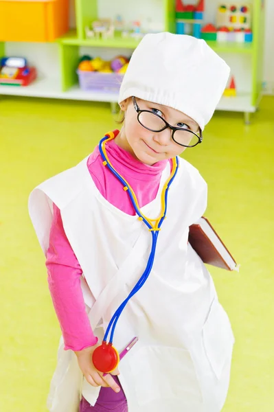 Cute little girl playing in doctor — Stock Photo, Image